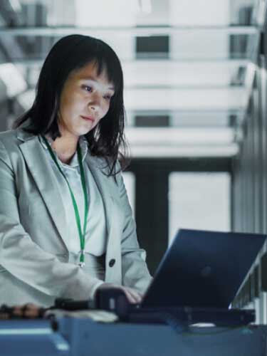 User accessing their laptop in a datacenter or office environment