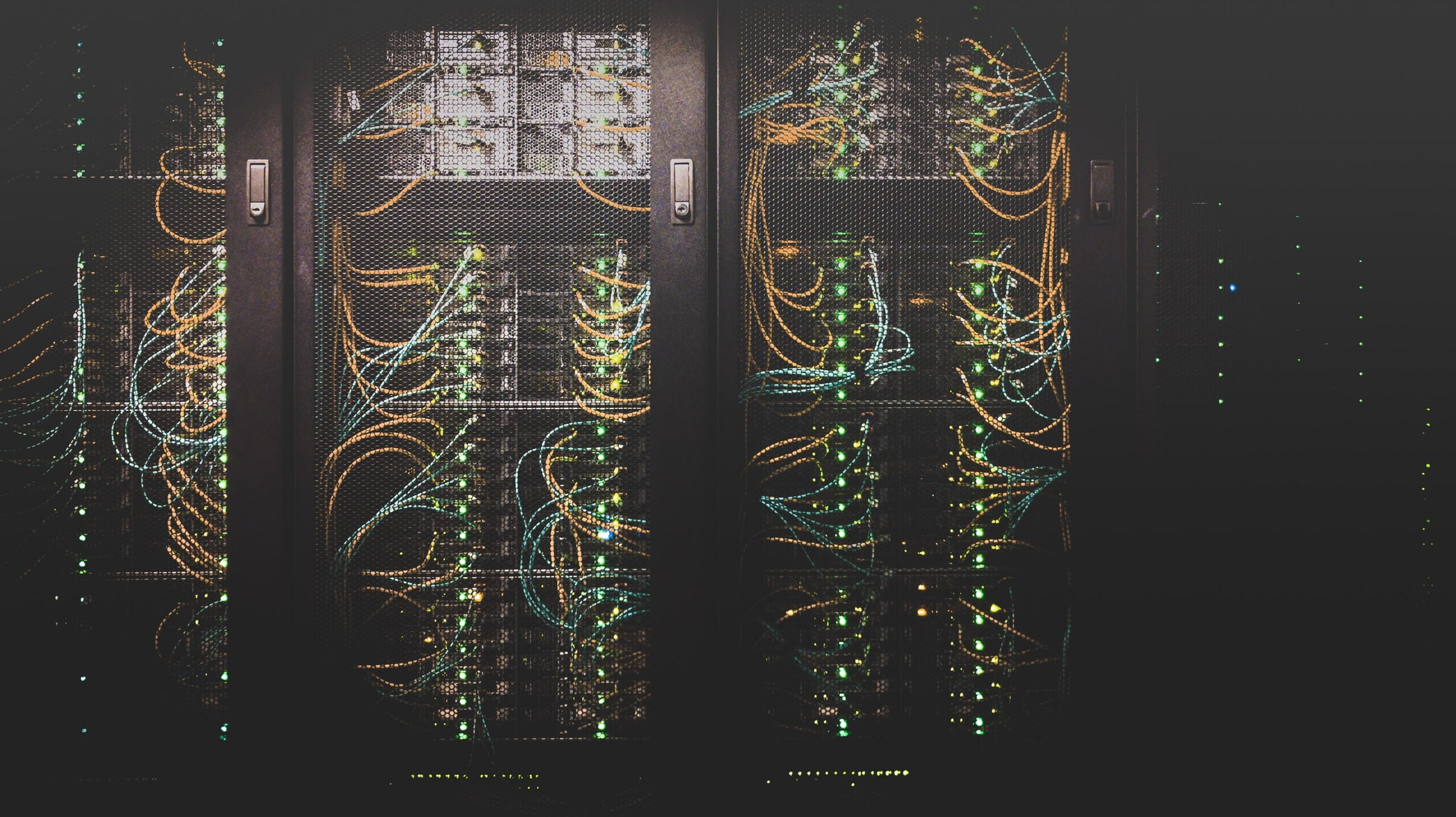 Datacenter racks with fiber optic and category cables installed.