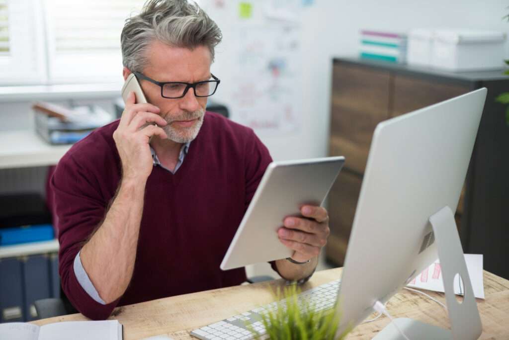 Business owner discussing how to choose a managed IT service provider with an IT consultant