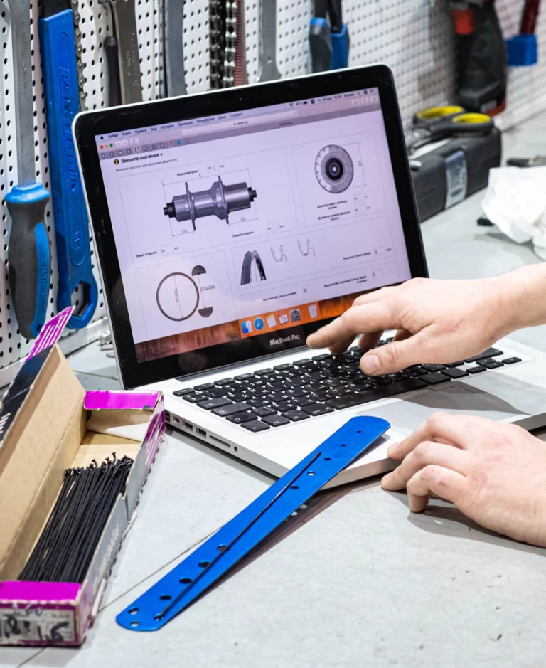 IT technician working on a laptop at a workbench