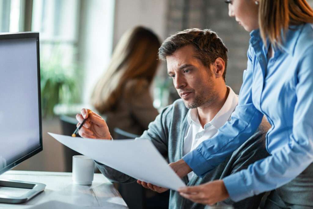 Business owner comparing managed IT provider proposals using a service checklist