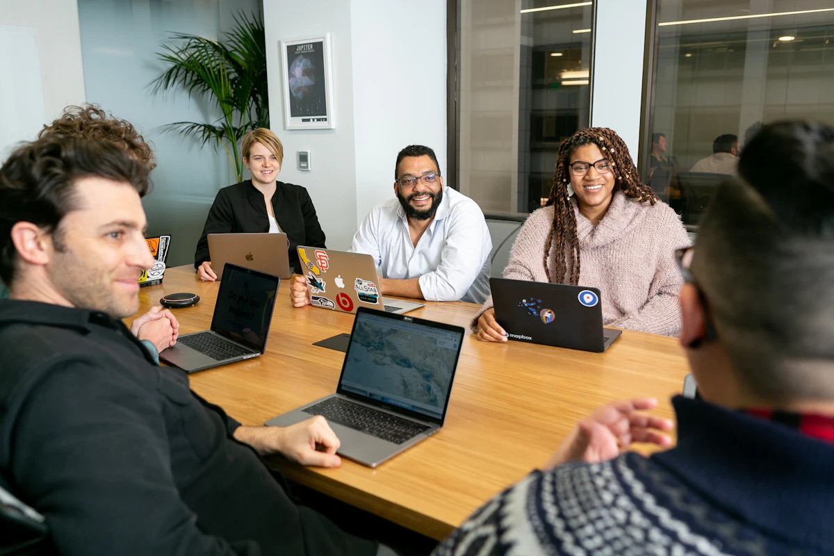 Small business team meeting with laptops